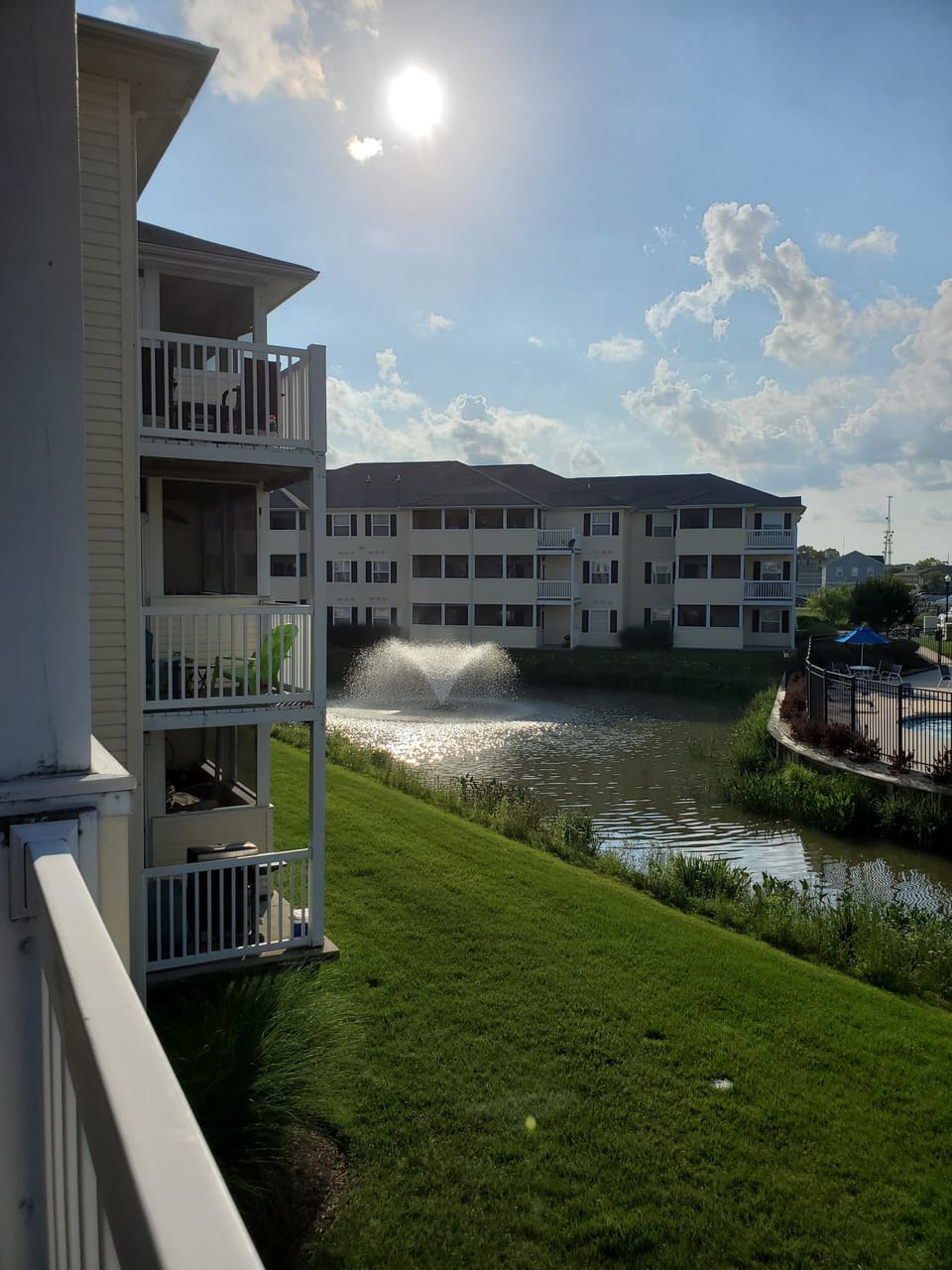 Balcony overlooks pond and pool