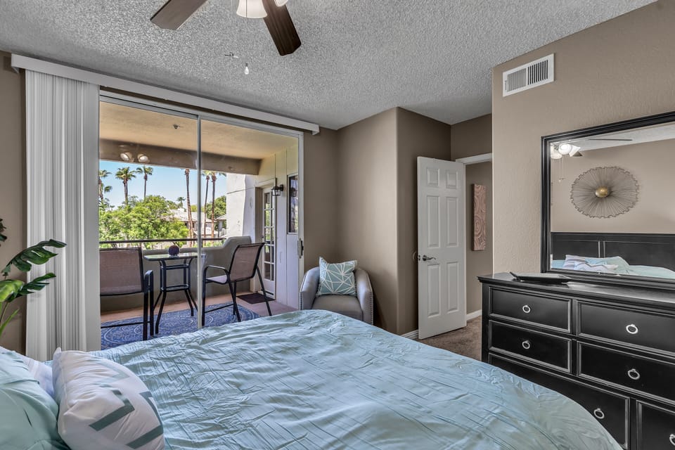 Master bedroom looks to patio and lake