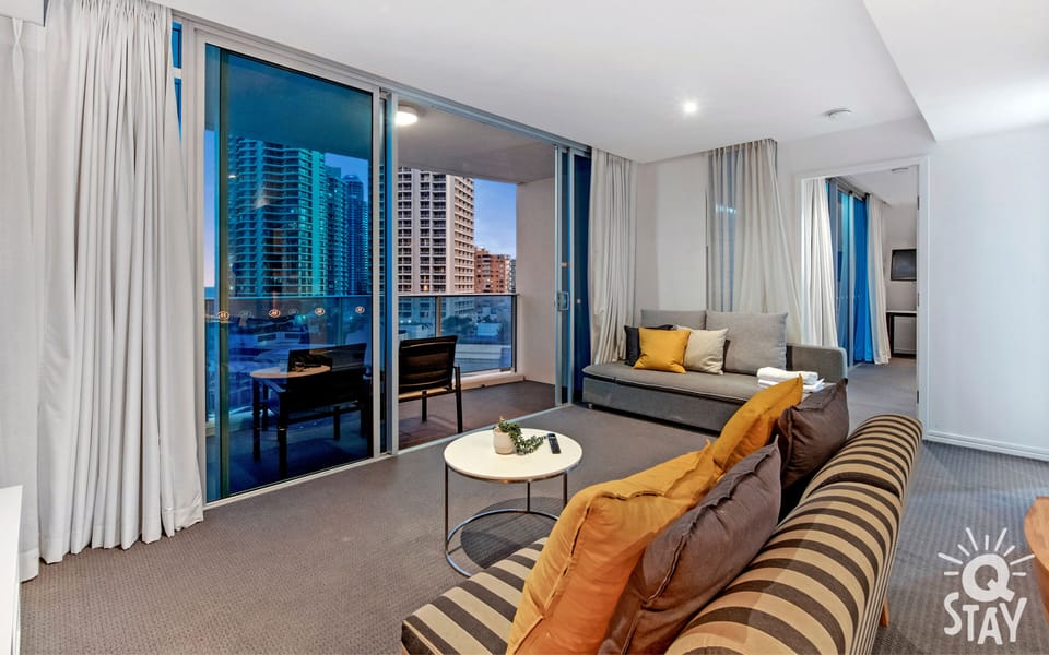 Cozy living room is right next to the balcony overlooking the ocean and the city