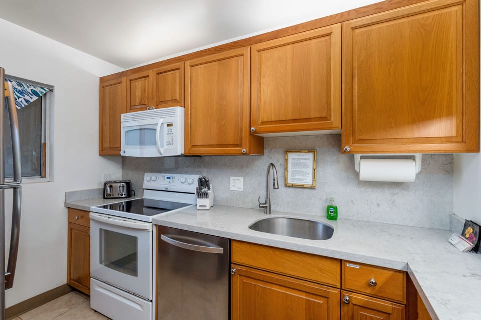 Well stocked with kitchen ware and appliances.