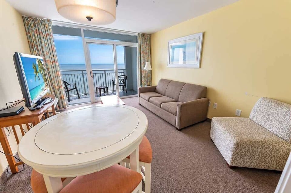- Enjoy breathtaking oceanfront views from your balcony in this cozy getaway - Relax in a comfortable living space with a sleeper sofa, TV, and dining area - Conveniently located near top attractions, restaurants, and the beach just steps away