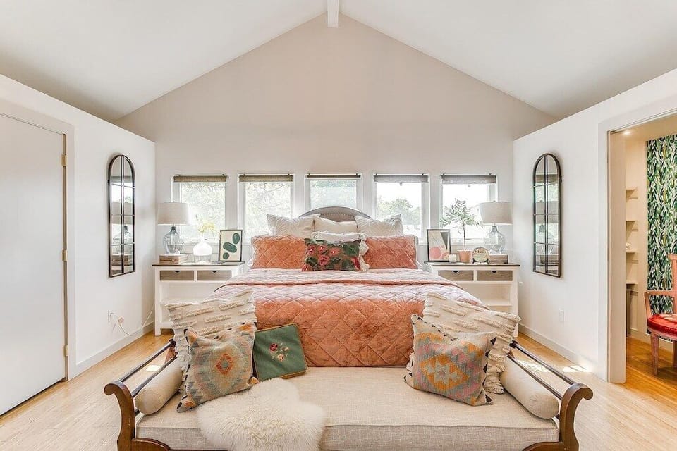 King bedroom with vaulted ceilings, layered linens, and calm Fort Worth retreat style.
