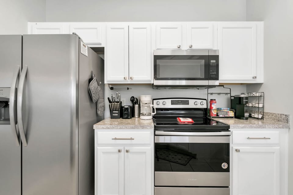 kitchen with Keurig coffee maker, regular coffee pot,  and tea kettle