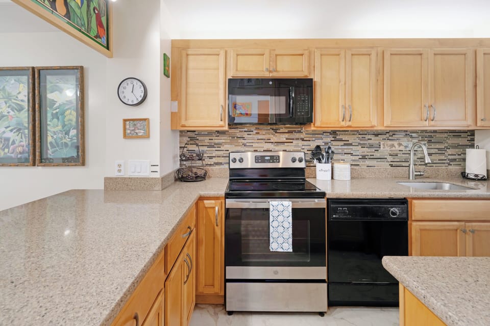 The granite and stainless-steel kitchen is perfect for dining in.