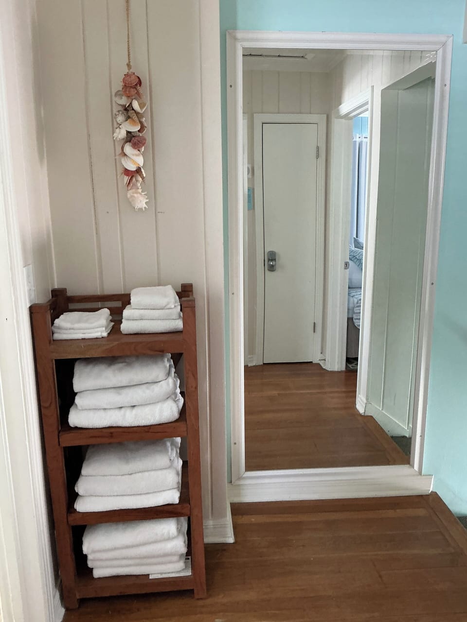 Hallway in between bedrooms, stocked with towels.