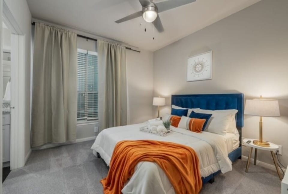 Bright Bedroom with Plush Queen Bed and Fully Rotational 42" Smart TV