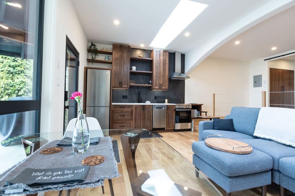 A bespoke walnut kitchen includes a dishwasher. Living is simple and easy here.
