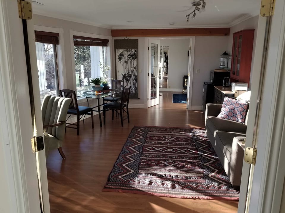Living room leading,  through french doors into bedroom