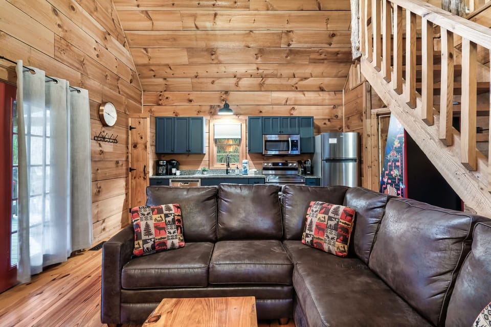 Open living space with leather seating and loft above