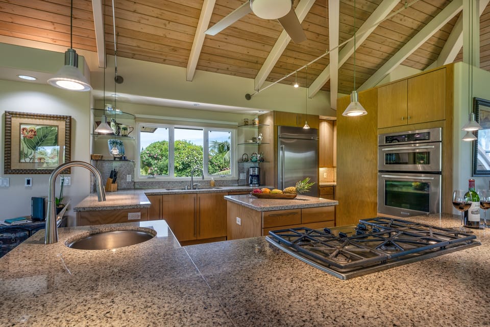 Propane cooktop, single sink in 2nd granite top island with bar stools