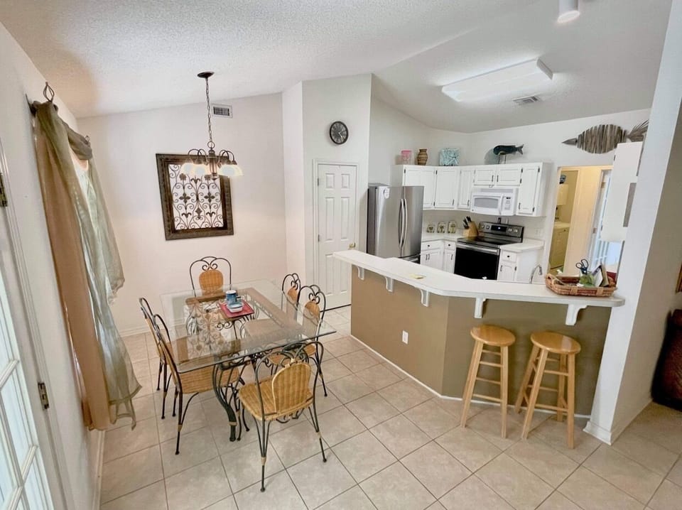 Seating for six in the breakfast room. More seating I. The sunroom.