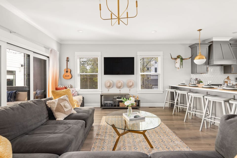Spacious living room with large flat-screen HD TV, stereo, and group games.