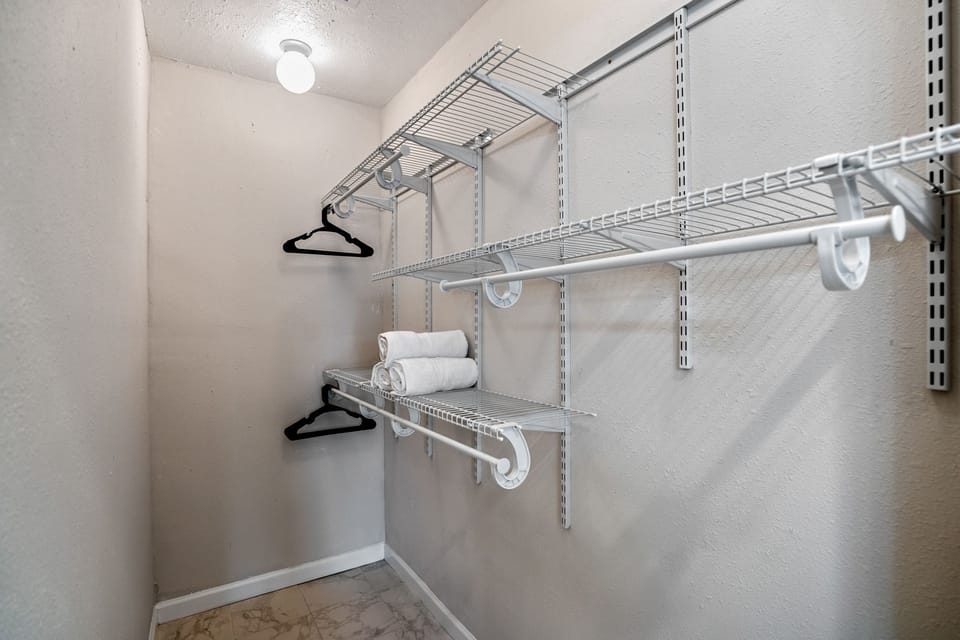Primary bedroom walk-in closet