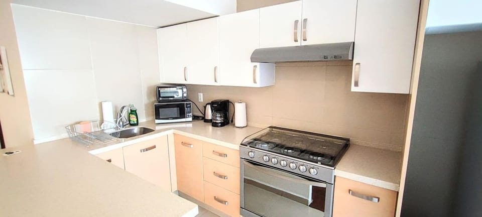The full kitchen is well-equipped with modern appliances, including a stove, refrigerator, and microwave. It also features ample countertop space and storage, allowing for convenient meal preparation and cooking during your stay.