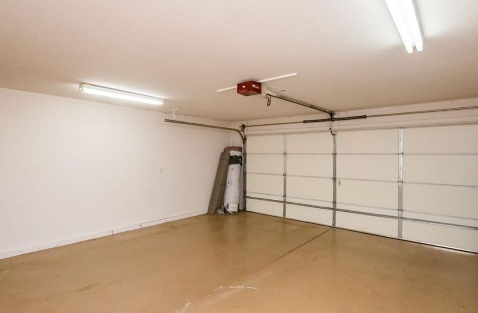  Two car garage , half of which is occupied by jet skis.