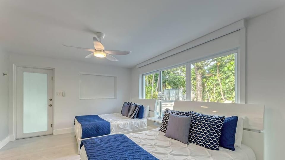 3rd Bedroom (Cabana Room) with 2 Double Beds, En-Suite Bathroom, Smart TV, Blackout Shades & Double doors for wide step free entrance to bedroom. 
