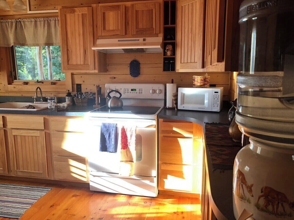 Well appointed kitchen with microwave, stove, coffee maker, blender, hot water heater, electric griddle, toaster