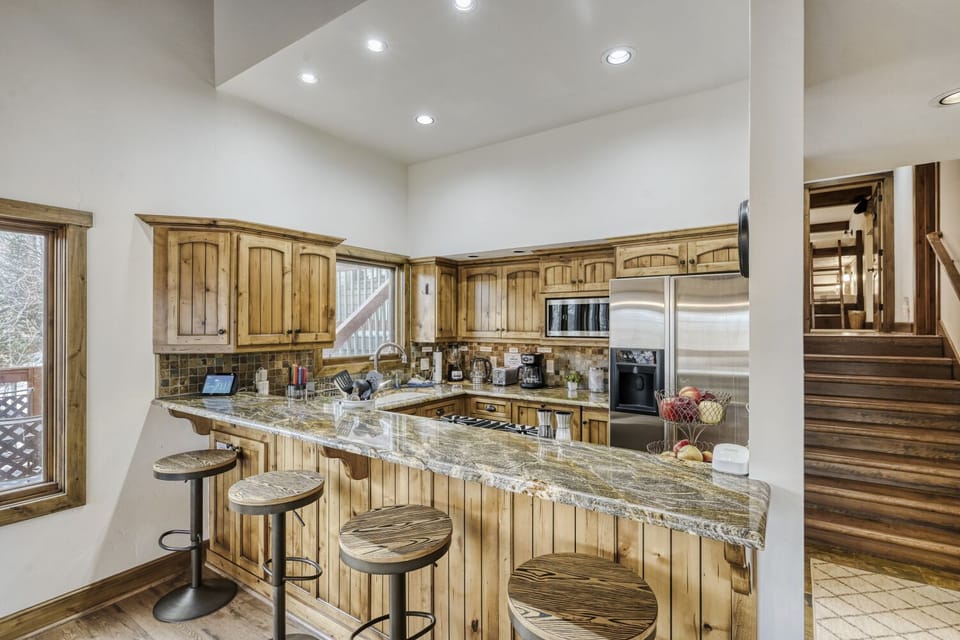 Gather around your spacious granite island for morning coffee or evening meals in this warm, rustic kitchen with modern appliances.
