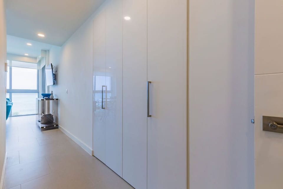 Elegant, minimalist hallway with ample storage and natural light welcoming you into your bright, contemporary retreat.