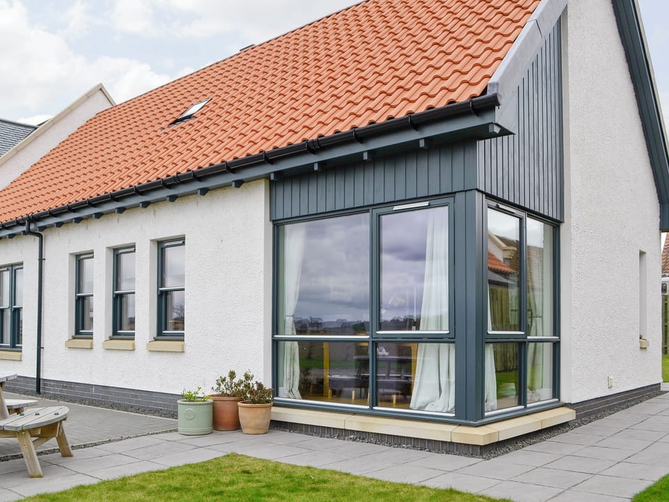Rear of property with paved path and patio | Strathspey - Paddockhall Cottages, Linlithgow, near Edinburgh 