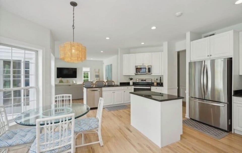Open concept kitchen with breakfast table and new appliances