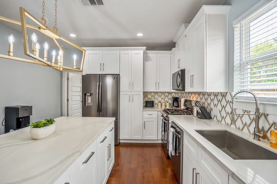 Fully stocked kitchen with all appliances and utensils.