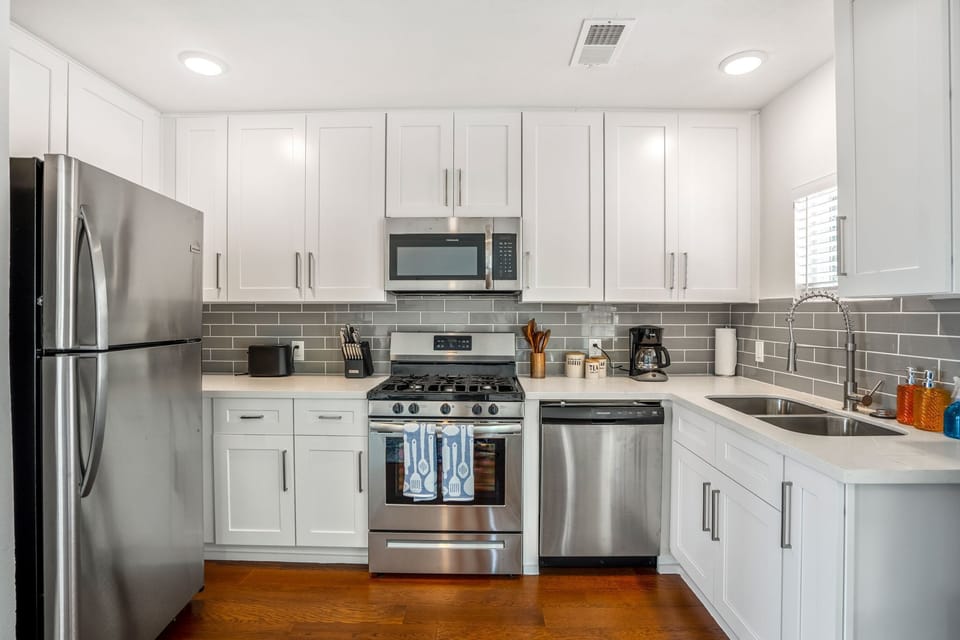 Fully stocked kitchen with all appliances and utensils.