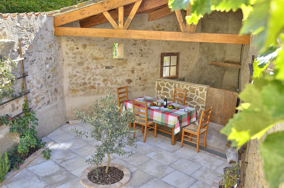 Courtyard with gas BBQ and shaded dining area