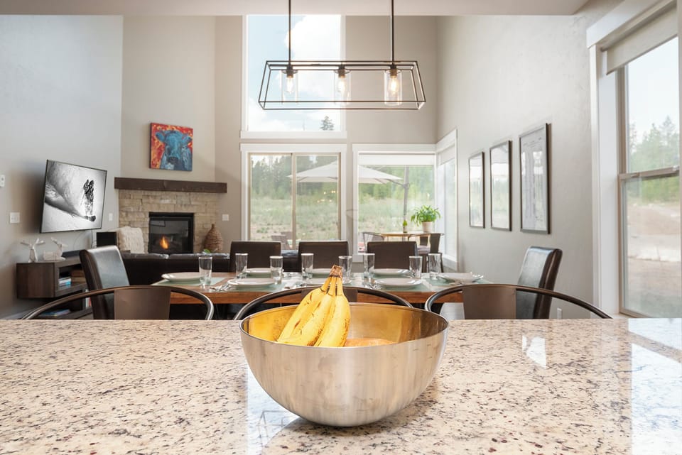 Your modern kitchen island opens to a dining space where you'll enjoy meals with fireplace views.