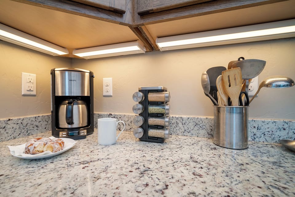 Start your morning right with premium coffee facilities and professional cooking tools at your fingertips in this beautifully appointed kitchen.