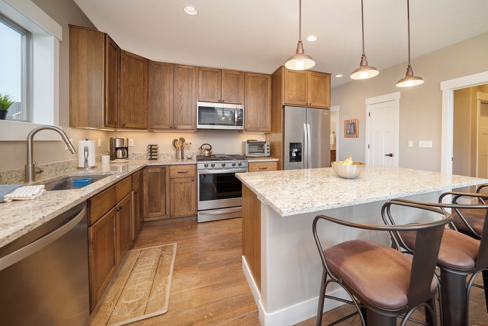 Whip up your favorite meals in this spacious kitchen featuring granite counters, stainless appliances, and a breakfast island perfect for morning coffee.