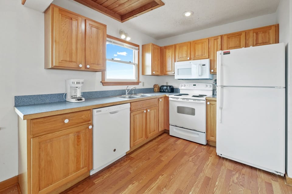Expansive kitchen featuring traditional appliances.
