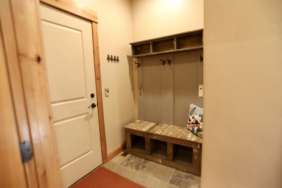 Garage entry with bench, key and coat hooks. Place to store hats and gloves.