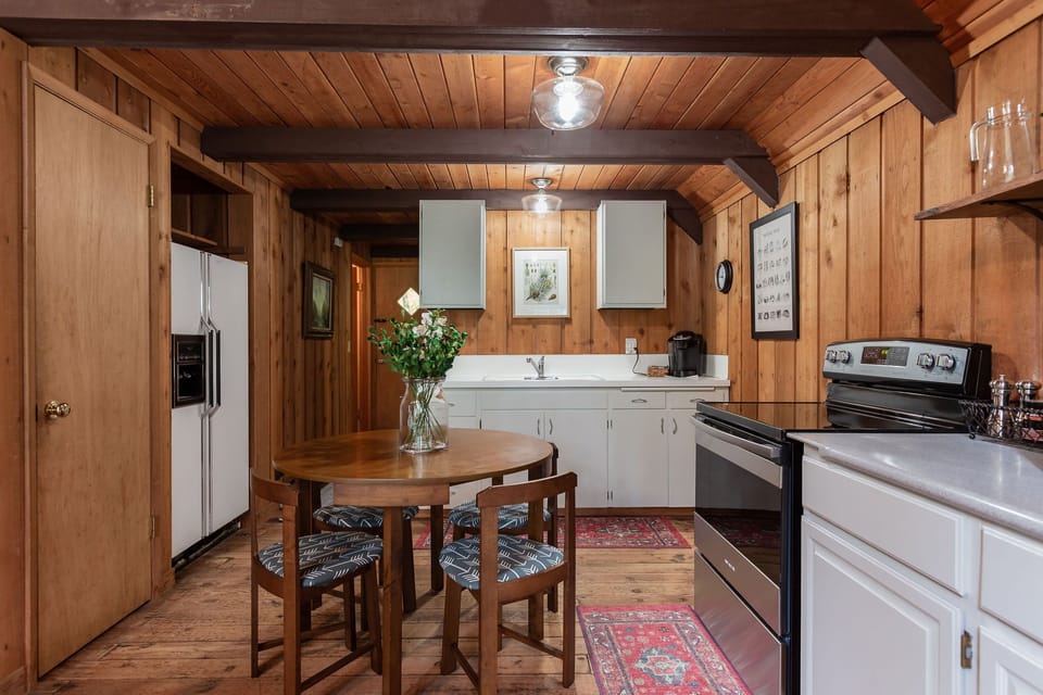 Open kitchen area with Keurig and space efficient dining table.