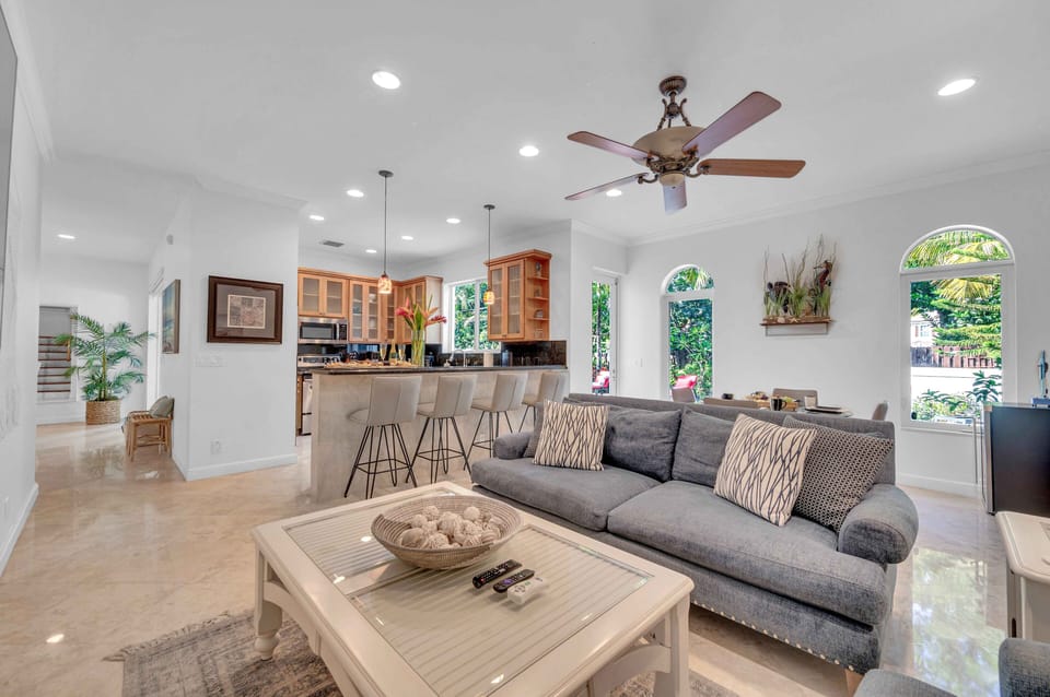 On the other side of the breakfast bar is the second, smaller living area. This living space has a comfy sofa and another wall mounted Smart T.V.