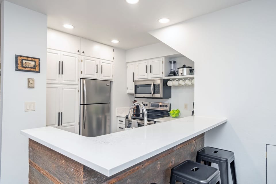 Updated kitchen with stainless steel appliances-electric oven, refrigerator, microwave and dishwasher.