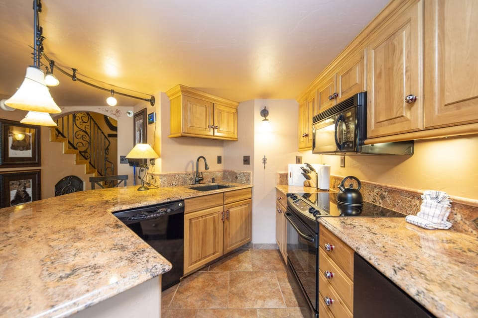 Full kitchen with small refrigerator/freezer.