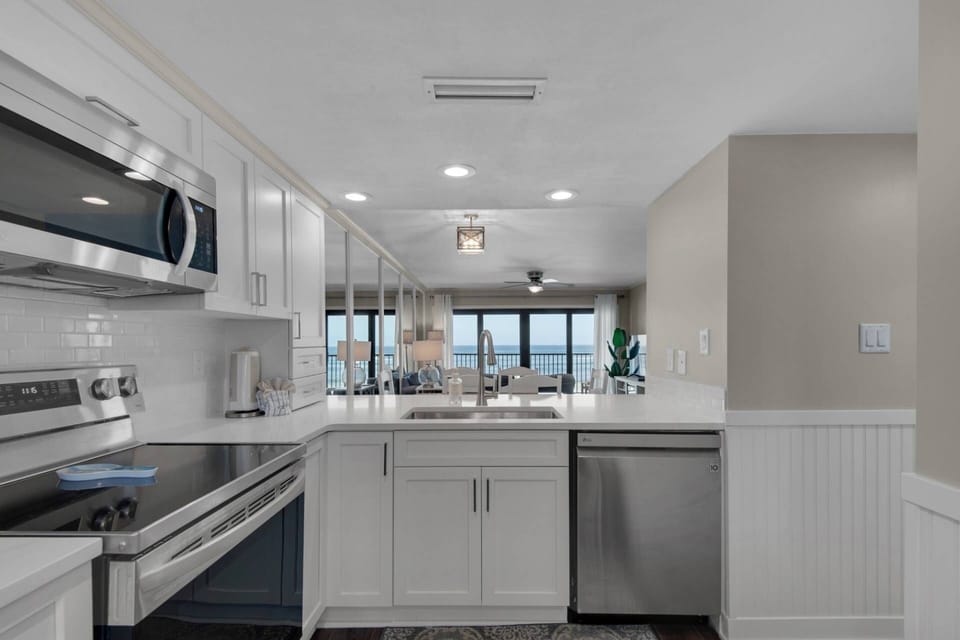 Kitchen area with view of living and dining areas.
