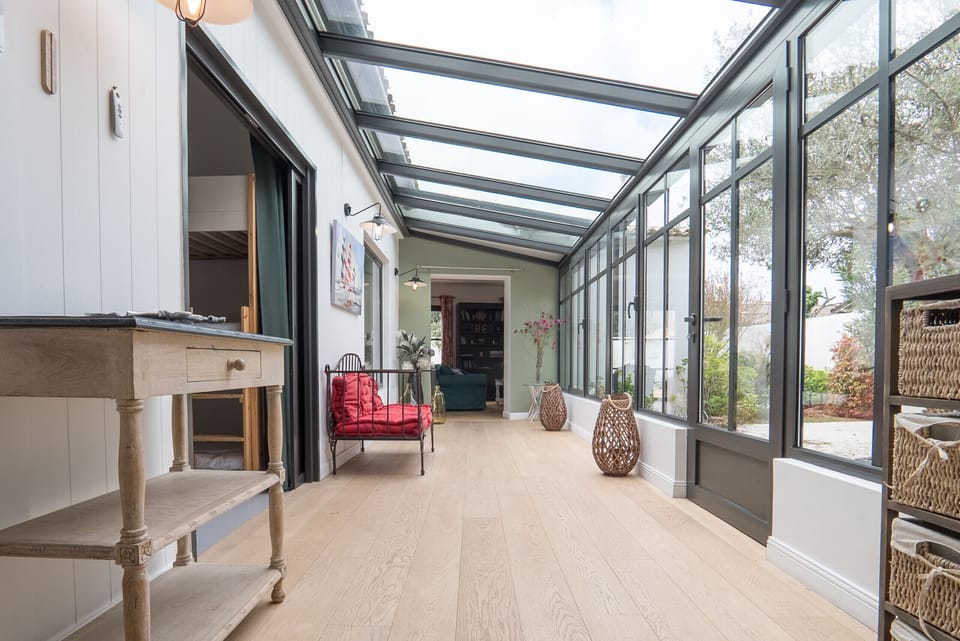 Corridor with glass roof leading to the living room