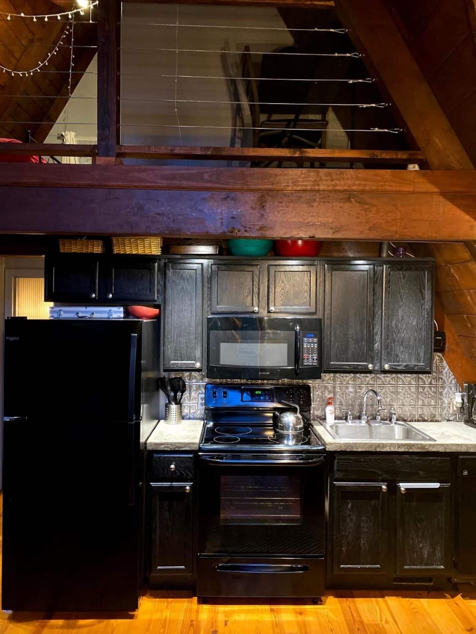 A simple kitchen, supplied with all of the cooking utensils anyone could ever need.