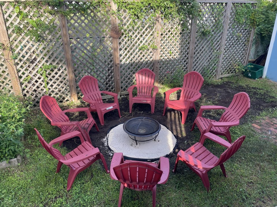 Fenced backyard with a fire pit