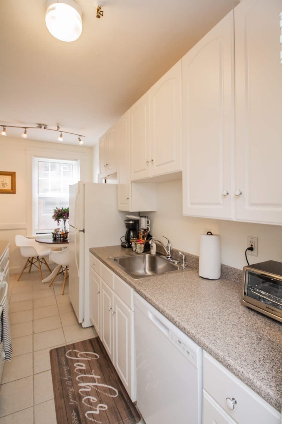 Kitchen is long and has lots of counter space and storage in the cabinets 