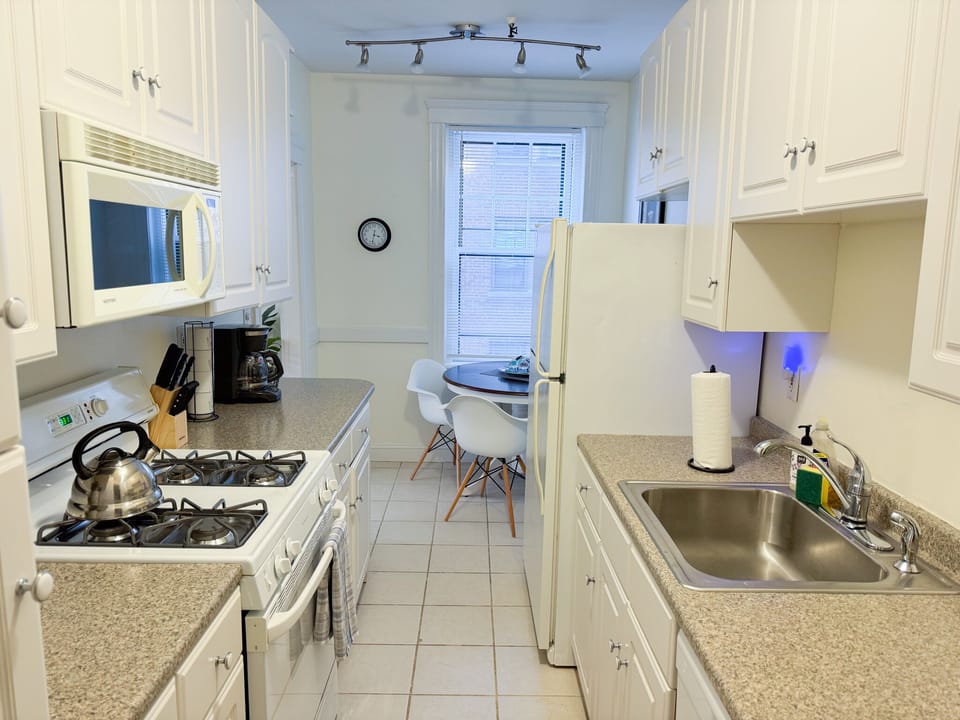 Kitchen has working space and lots of storage around the range
