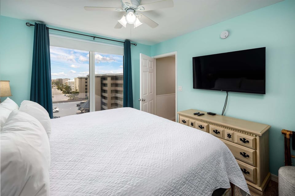 Master bedroom with TV and balcony access