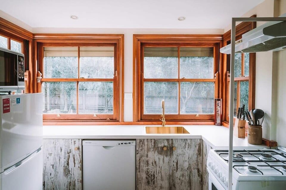 While retaining its rustic charm, the kitchen is updated with contemporary brass tap ware, combining old-world style with modern convenience.
