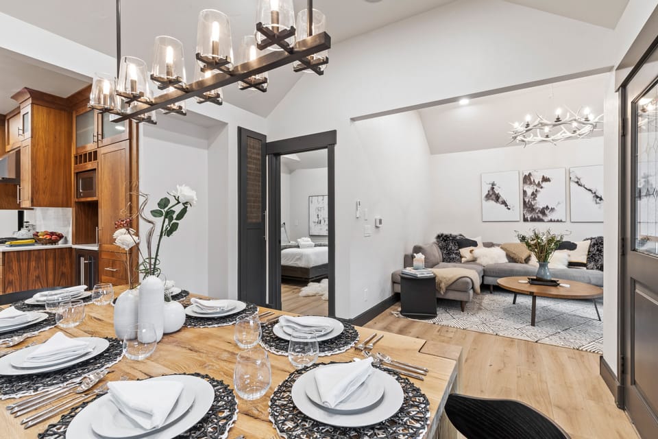 Gather for meals in this bright dining area with vaulted ceilings, seating for eight, and seamless access to the well-appointed kitchen. A stylish and comfortable gathering spot.