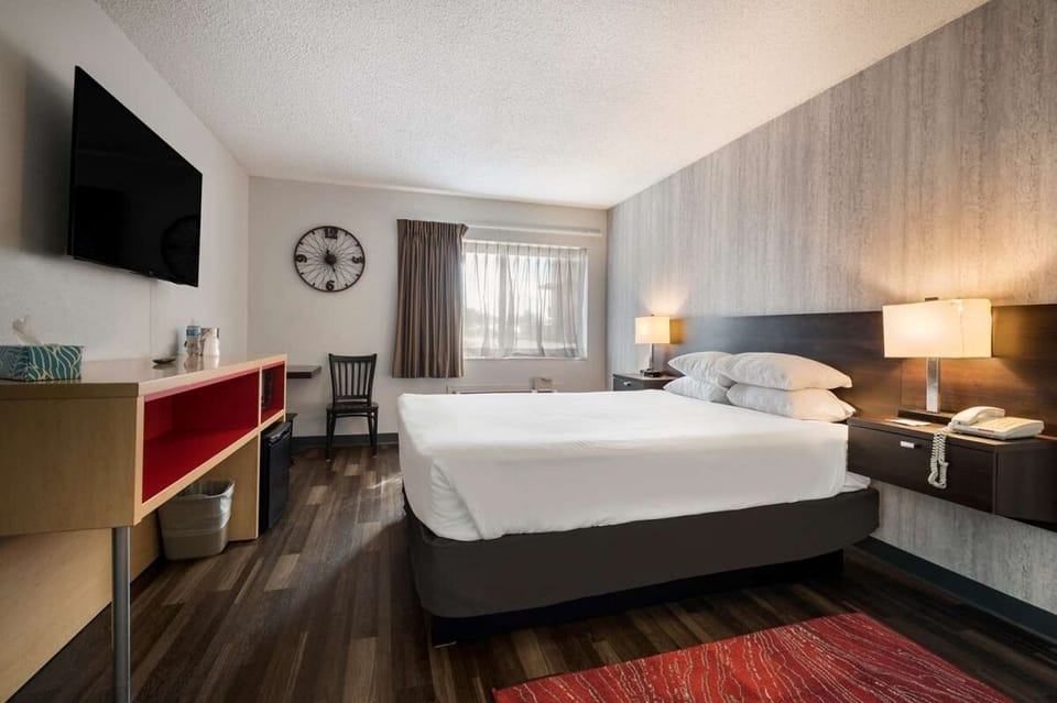 Settle in with a cozy bed, TV, and easy workspace