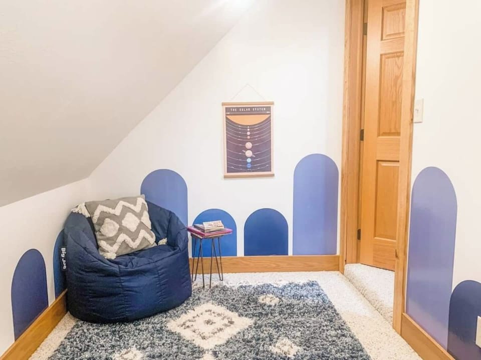 This comfy corner, nestled into one of the upstairs queen sleeping nooks, is a kid-favorite for calm moments and story time.