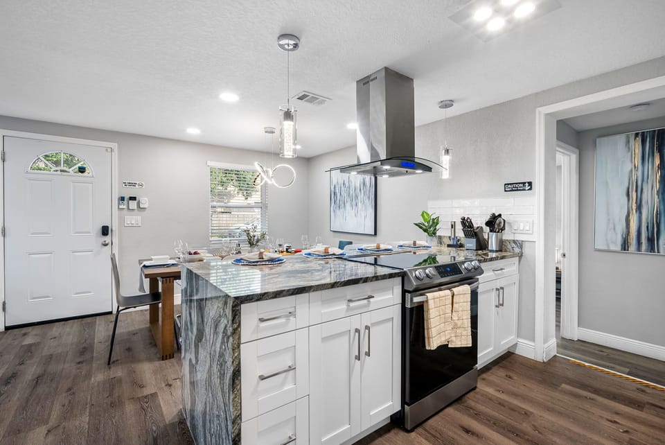 This fully equipped kitchen features stainless steel appliances, sleek cabinetry, and elegant granite countertops — perfect for cooking and entertaining.