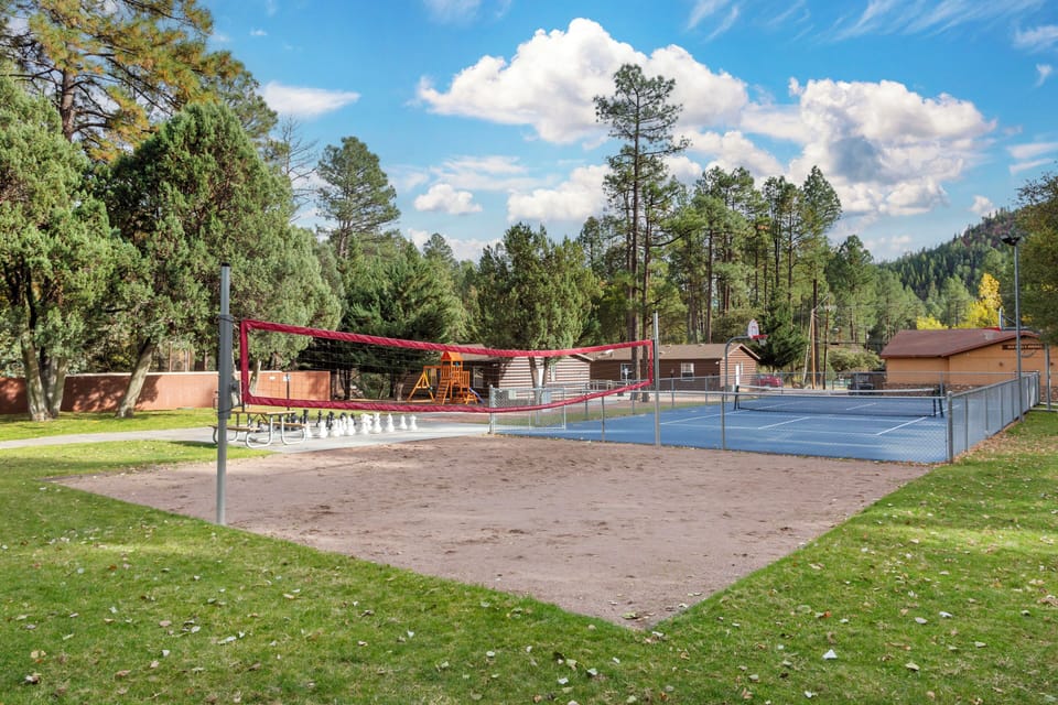 Serve and volley beside mountain views on the sand court.